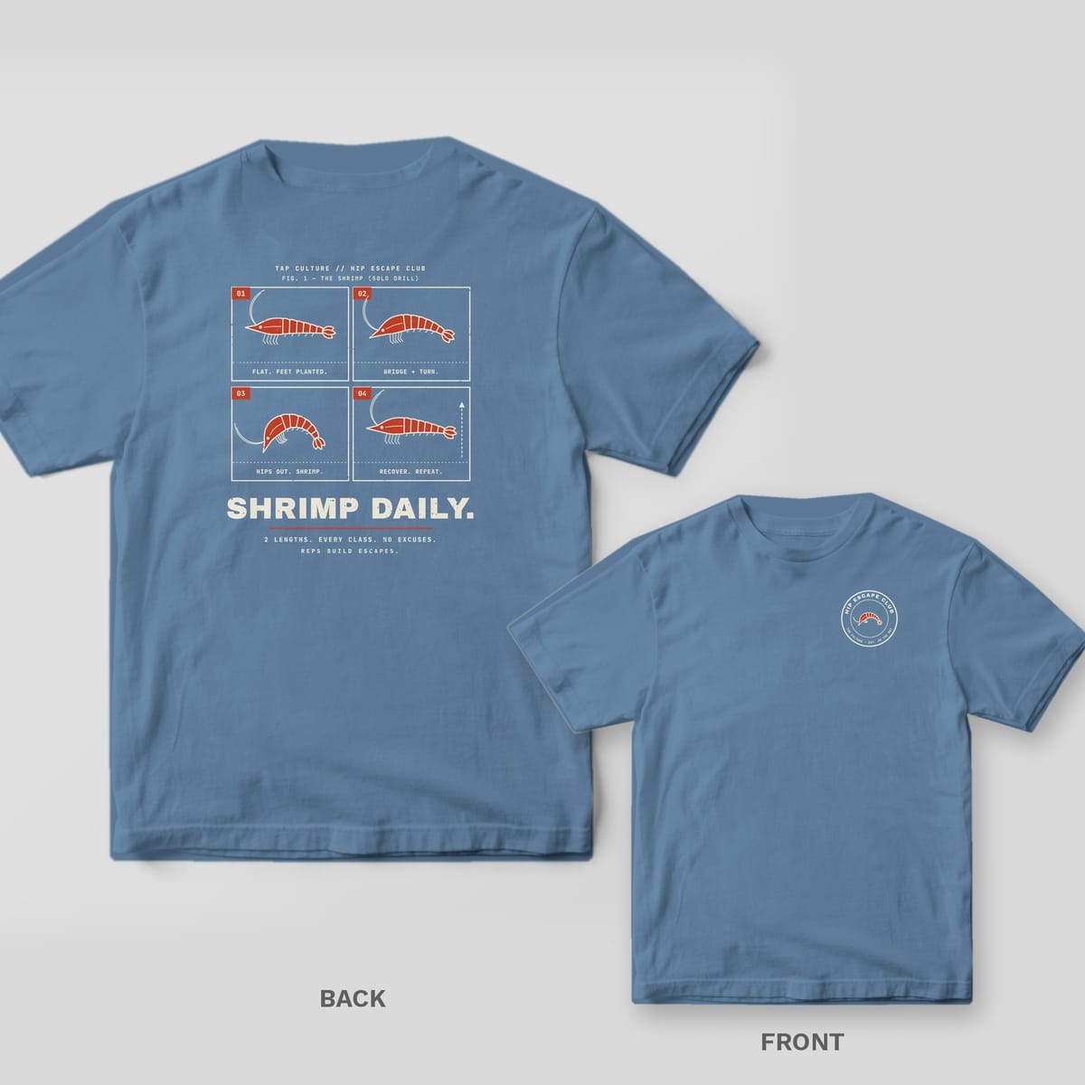 Blue Jean Comfort Colors tee, back and front: four-panel shrimp hip-escape drill with SHRIMP DAILY, and a round HIP ESCAPE CLUB badge on the chest.