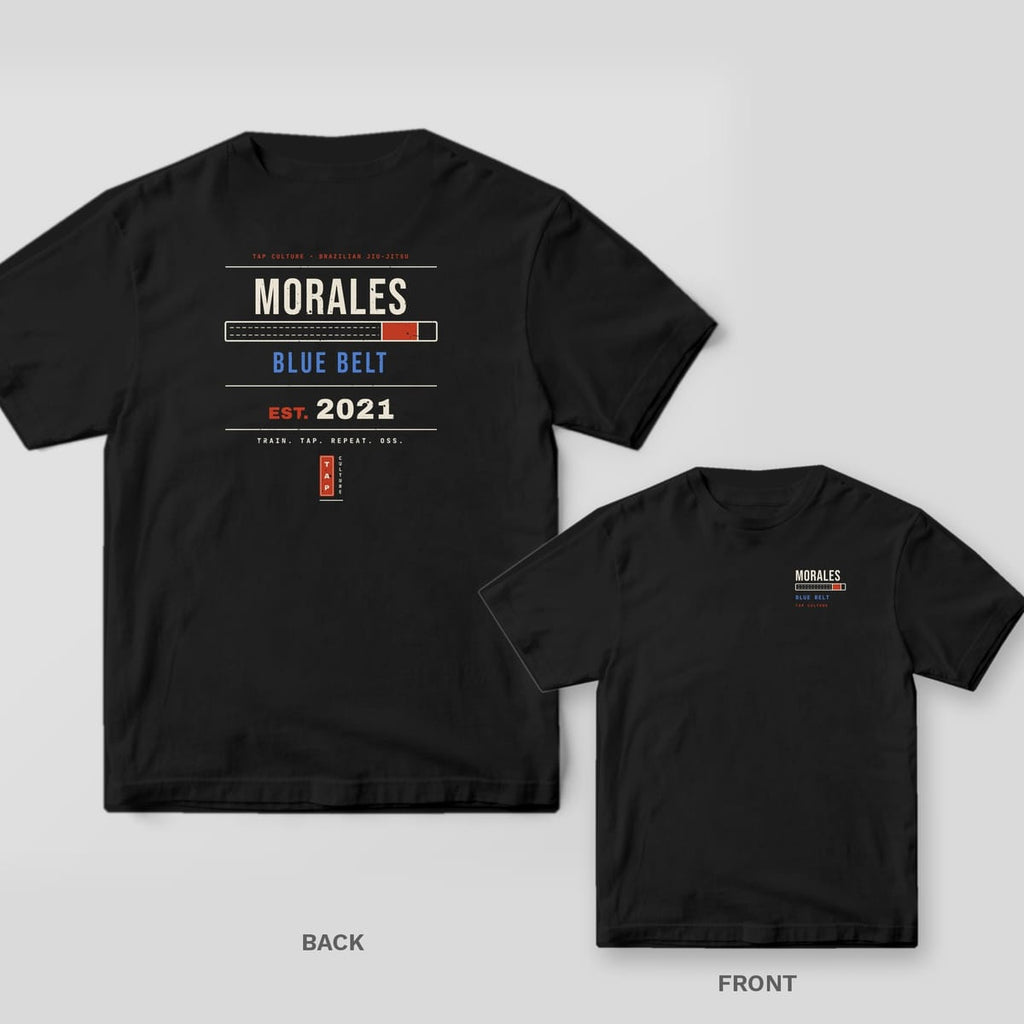Black Comfort Colors tee, back and front: custom name MORALES, a belt bar, BLUE BELT and EST. 2021 on the back, name and rank on the chest.