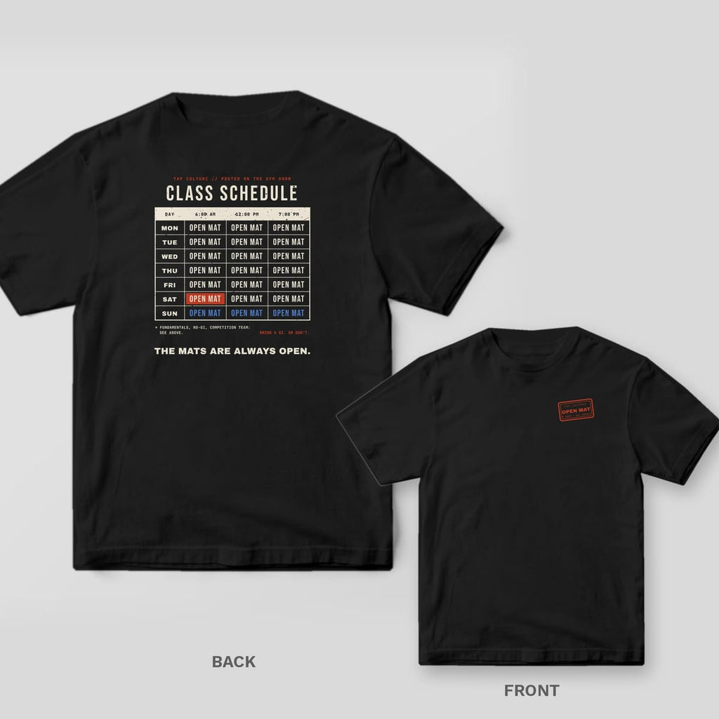 Black Comfort Colors tee, back and front: weekly class schedule where every slot says OPEN MAT, and a red OPEN MAT stamp on the chest.