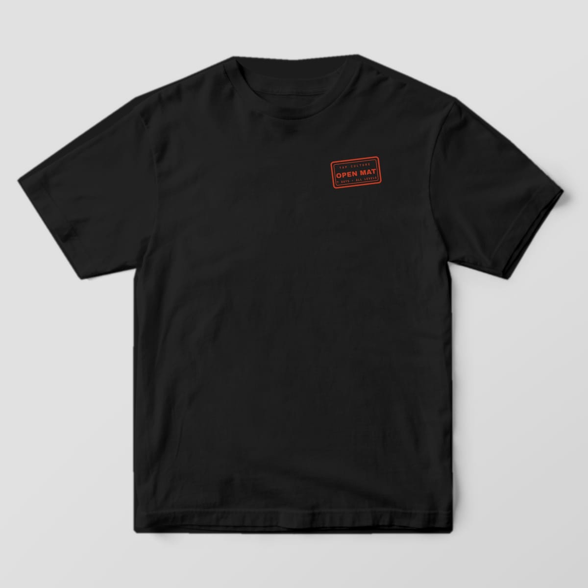 Front of a black Comfort Colors 1717 tee with a small red OPEN MAT rubber-stamp logo on the left chest.