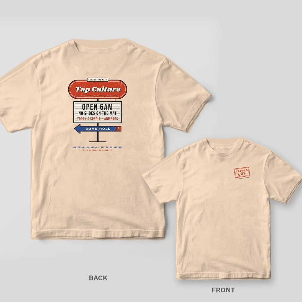 Ivory tee shown back and front: retro diner sign reading Tap Culture, Open 6AM, No Shoes on the Mat on the back, red TAPPED OUT stamp on the chest.