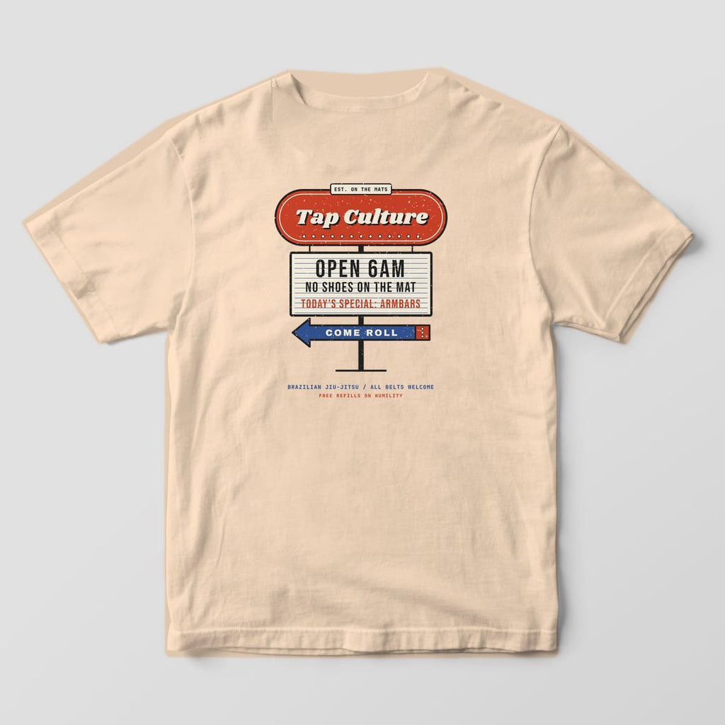 Back of an ivory Comfort Colors 1717 tee with a red Tap Culture diner sign, cream letterboard and blue Come Roll arrow.