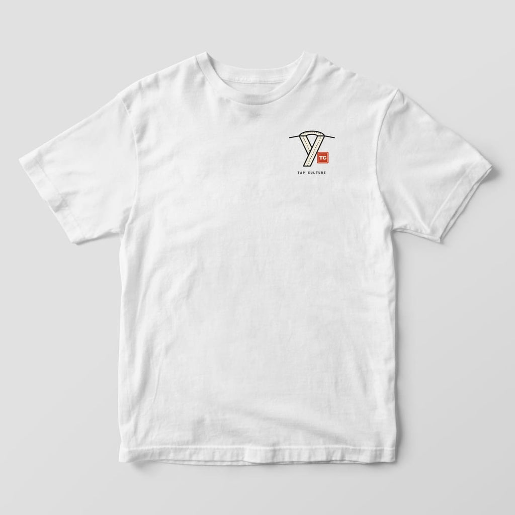 Front of a white Comfort Colors 1717 tee with a crossed gi collar drawing, a red TC seal and TAP CULTURE on the left chest.