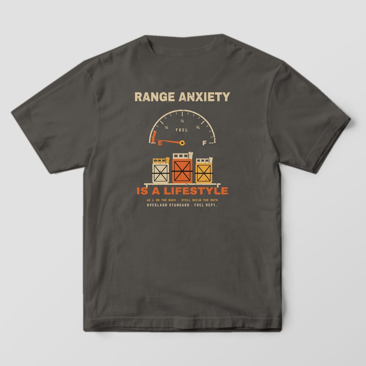 Back of a Pepper Comfort Colors 1717 tee with a sand fuel gauge, orange needle on E, three jerry cans on a rack and the words Range Anxiety Is a Lifestyle.