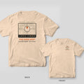 Back and front of a ivory Comfort Colors T-shirt with a topo map coordinate badge with a crosshair, orange map pin, latitude and longitude and the words The Good Spot; small chest print on the front