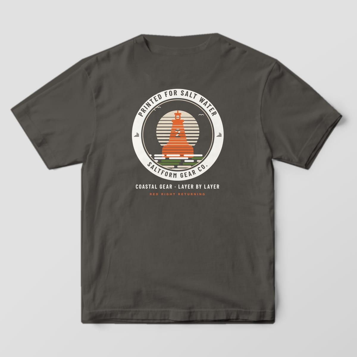 Back of a pepper gray Comfort Colors 1717 tee with an orange layered buoy inside a cream badge ring and COASTAL GEAR · LAYER BY LAYER.