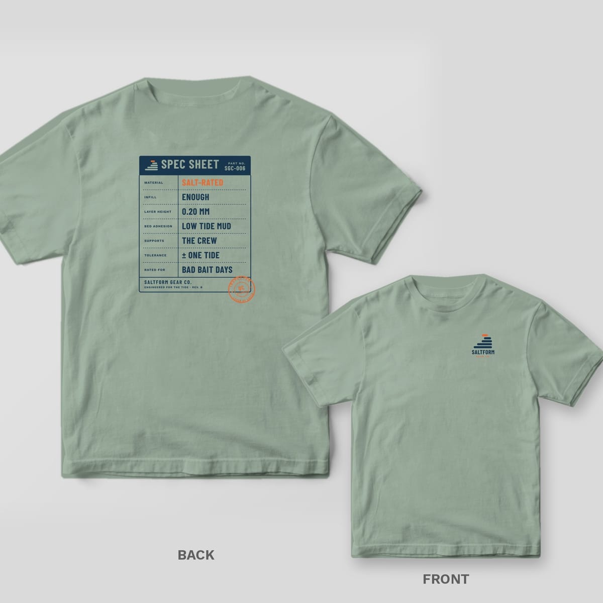 Bay green Comfort Colors tee back and front: navy spec sheet card with SALT-RATED and LOW TIDE MUD on the back, Saltform logo on the chest.