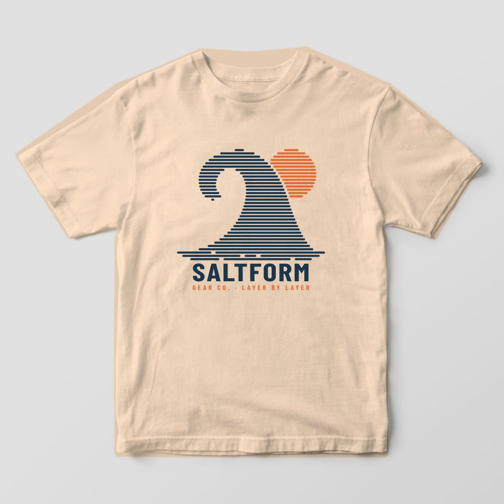 Front of an ivory Comfort Colors tee with a large navy layered wave and orange sun over the SALTFORM wordmark.