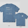 Blue jean Comfort Colors tee back and front: cream dock cleat blueprint with title block on the back, SGC gear tag on the chest.