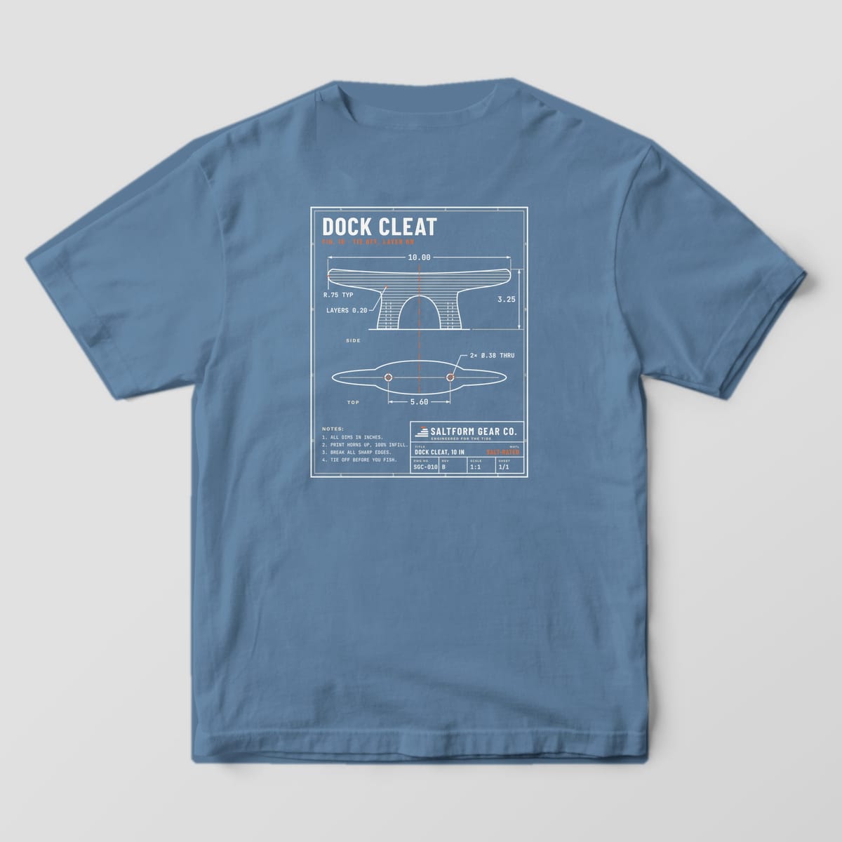 Back of a blue jean Comfort Colors 1717 tee with a cream engineering drawing of a dock cleat, dimensions and an orange centerline.