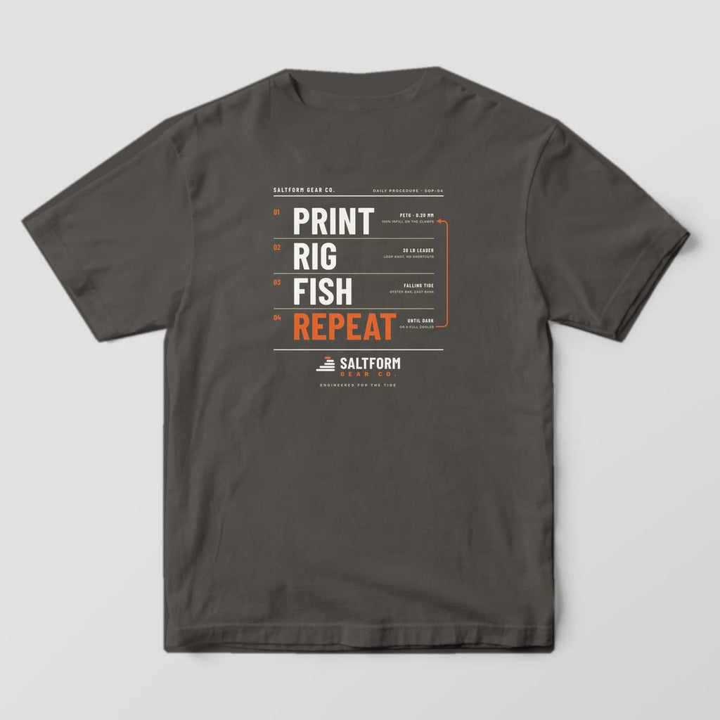 Back of a pepper Comfort Colors 1717 tee with numbered PRINT, RIG, FISH, REPEAT type in salt white and orange.