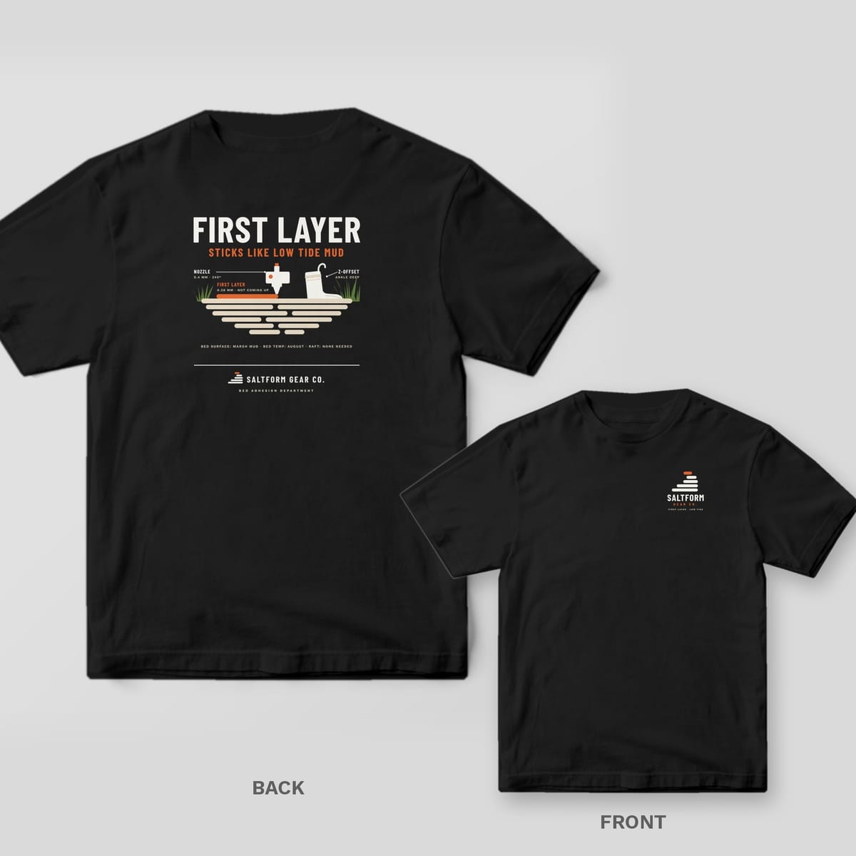 Black Comfort Colors tee shown back and front: FIRST LAYER STICKS LIKE LOW TIDE MUD diagram on the back, Saltform logo on the chest.