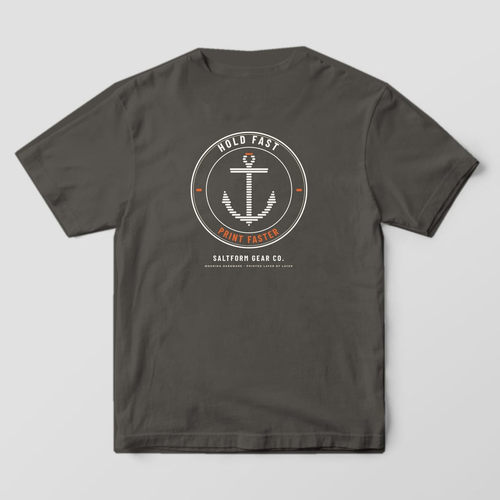 Back of a pepper Comfort Colors 1717 tee with a round badge and an anchor built from horizontal print layers.