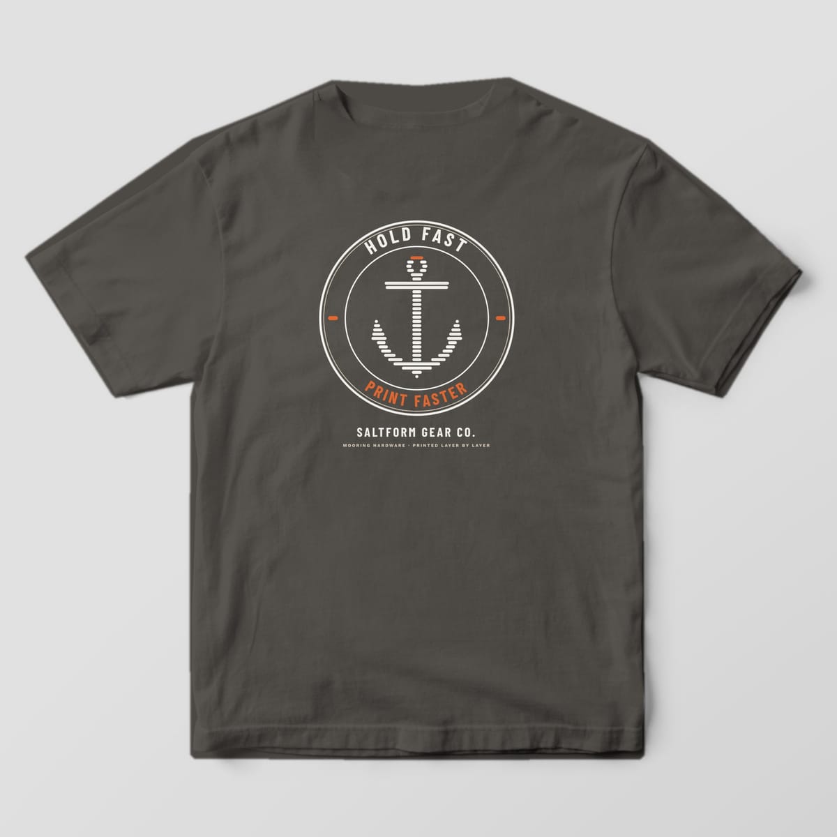 Back of a pepper Comfort Colors 1717 tee with a round badge and an anchor built from horizontal print layers.