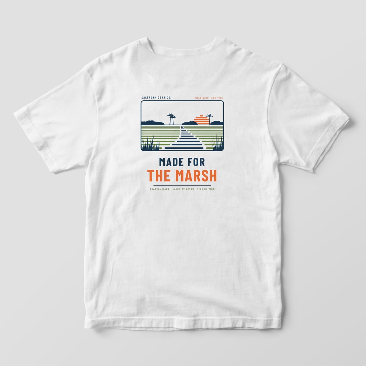 Back of a white Comfort Colors 1717 tee with a salt marsh scene in navy, green and orange layer lines over MADE FOR THE MARSH.