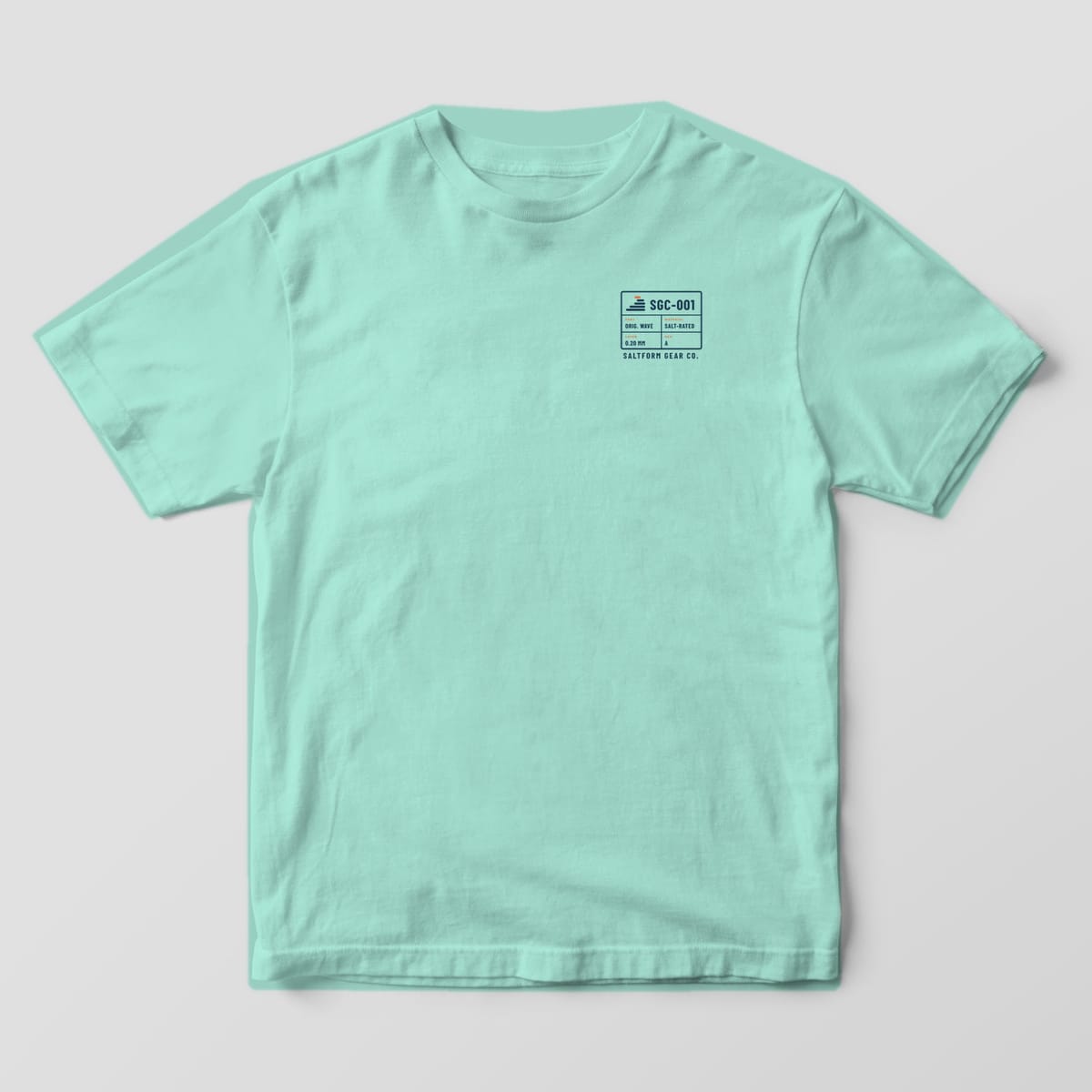 Front of a chalky mint Comfort Colors 1717 tee with a small navy spec block reading SGC-001 on the left chest.