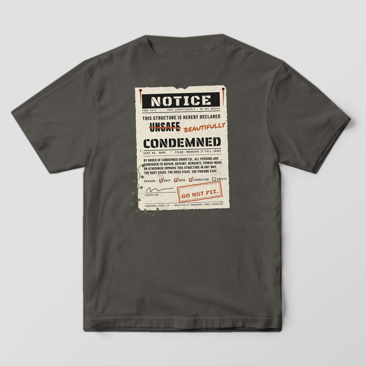 Back of a pepper Comfort Colors 1717 tee with a large nailed-up notice print reading This Structure Is Hereby Declared Beautifully Condemned.