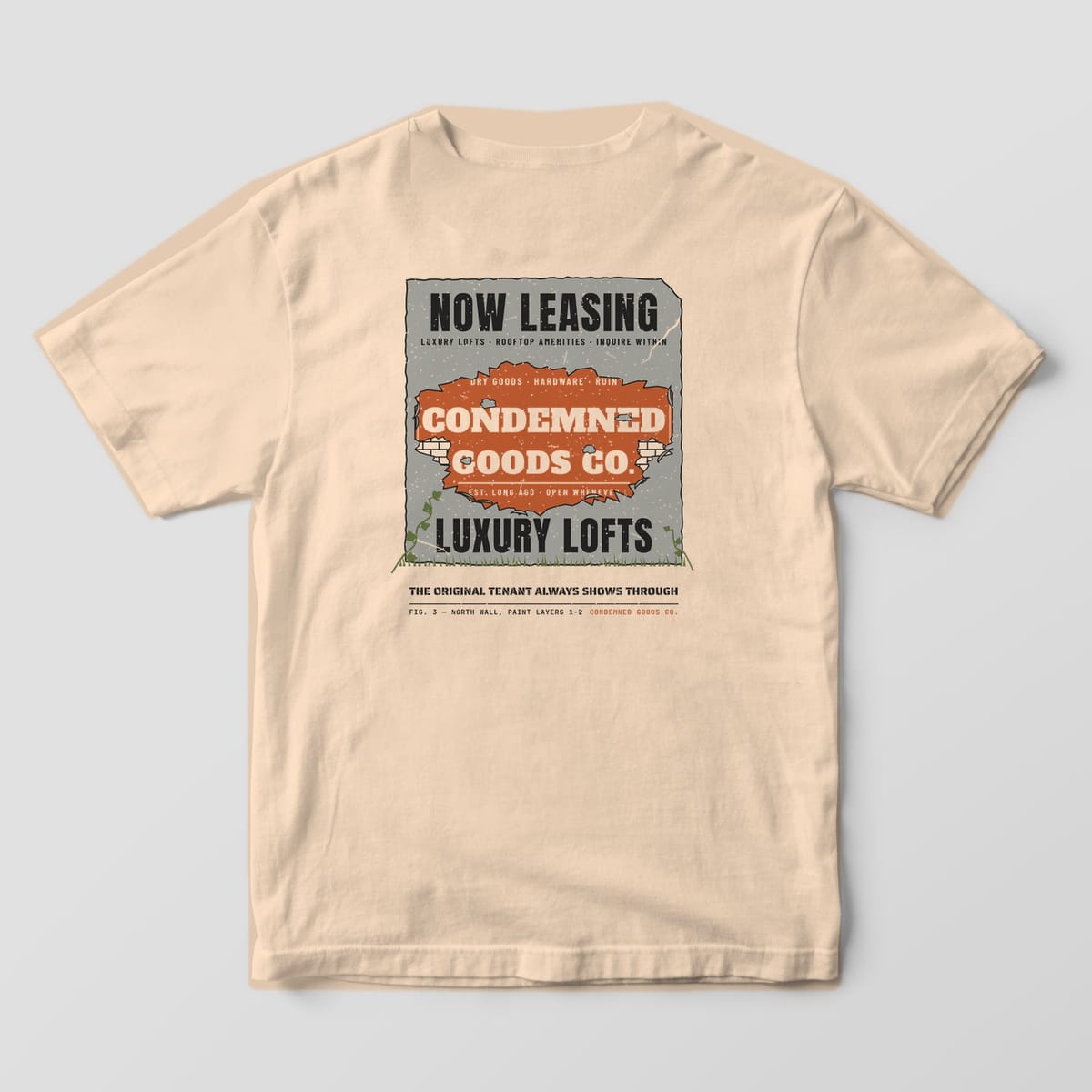Back of an ivory Comfort Colors 1717 tee with a peeling-paint wall print revealing an old rust ghost sign under a Luxury Lofts ad.