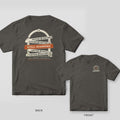 Pepper tee shown back and front: back has a brick archway covered in cream caution tape with a rust Still Standing strip; front has a round seal with caution tape.