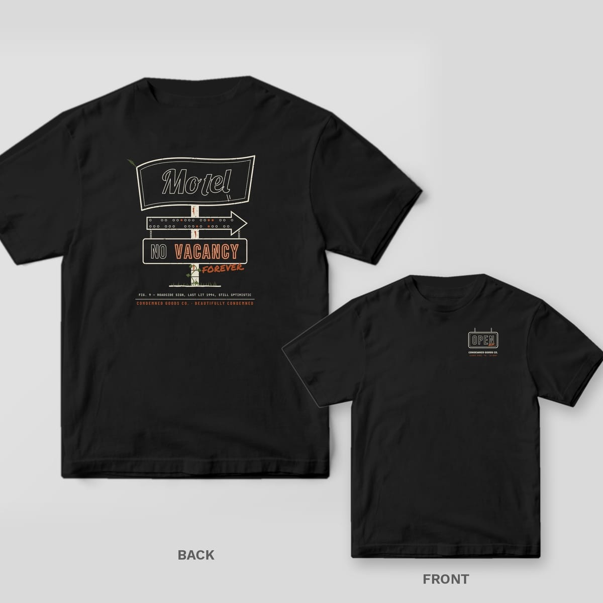 Black tee shown back and front: back has a roadside motel sign with dead cream neon and VACANCY lit in rust; front has a small dead neon OPEN sign.