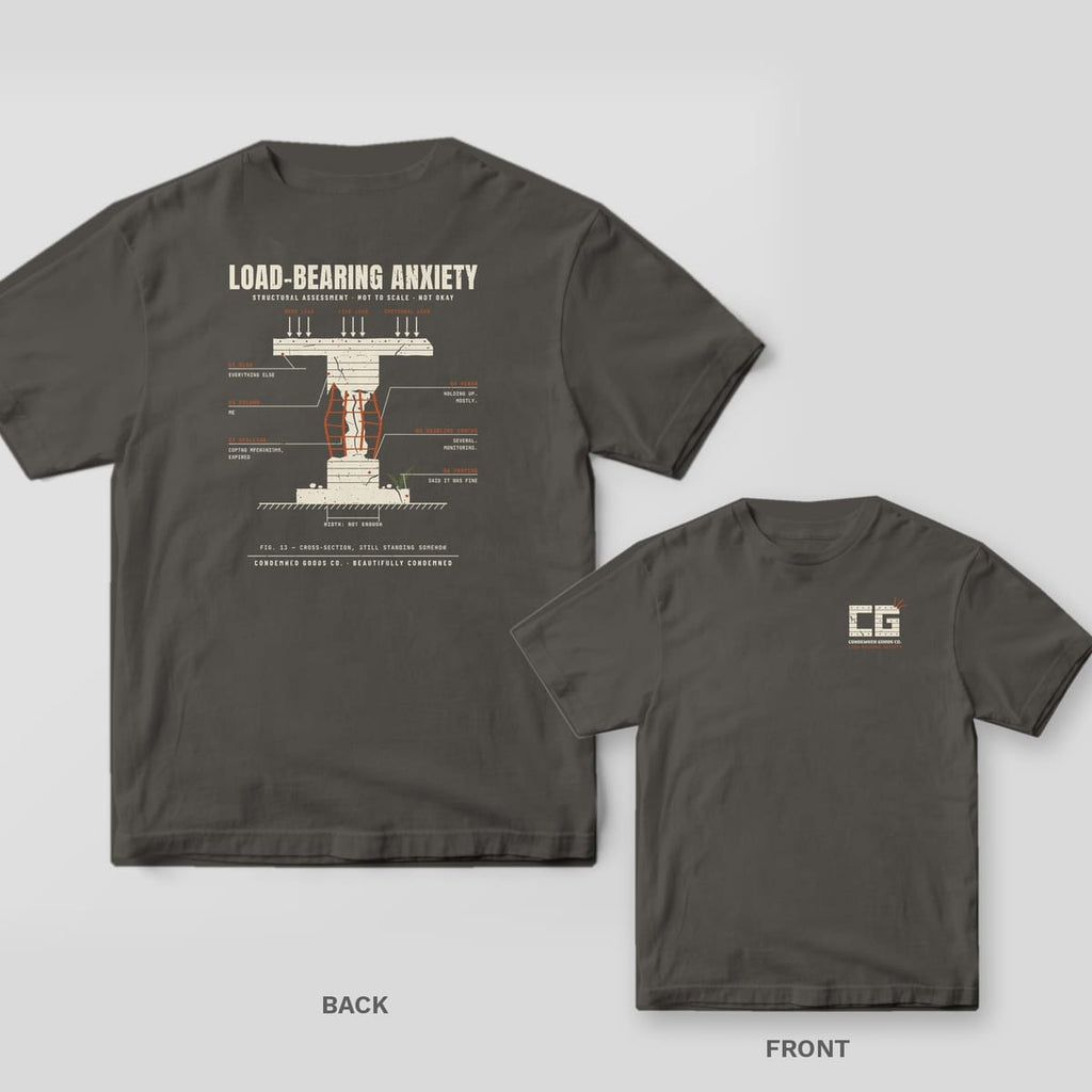 Pepper tee shown back and front: back has a cream concrete column with exposed rust rebar and engineering callouts under the words Load-Bearing Anxiety; front has a small concrete CG monogram with rust rebar.
