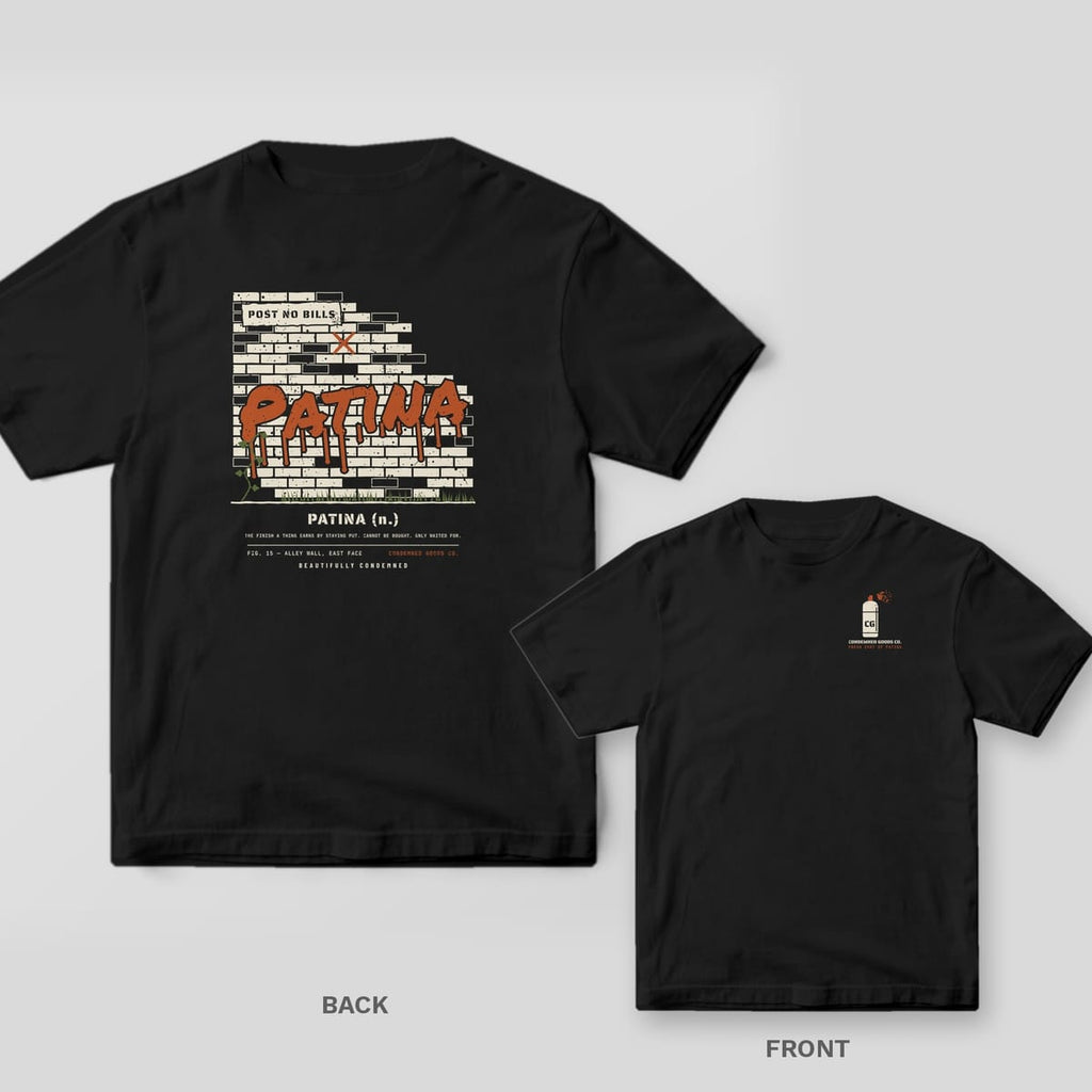 Black tee shown back and front: back has a cream brick wall with the word Patina spray-painted in dripping rust; front has a small cream spray can with a rust spray mist.