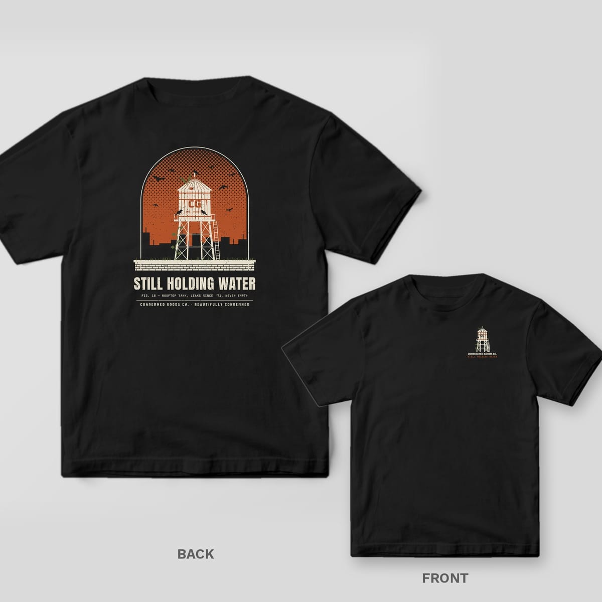 Black tee shown back and front: back has a cream rooftop water tower against a rust dusk sky with crows under the words Still Holding Water; front has a small water tower.