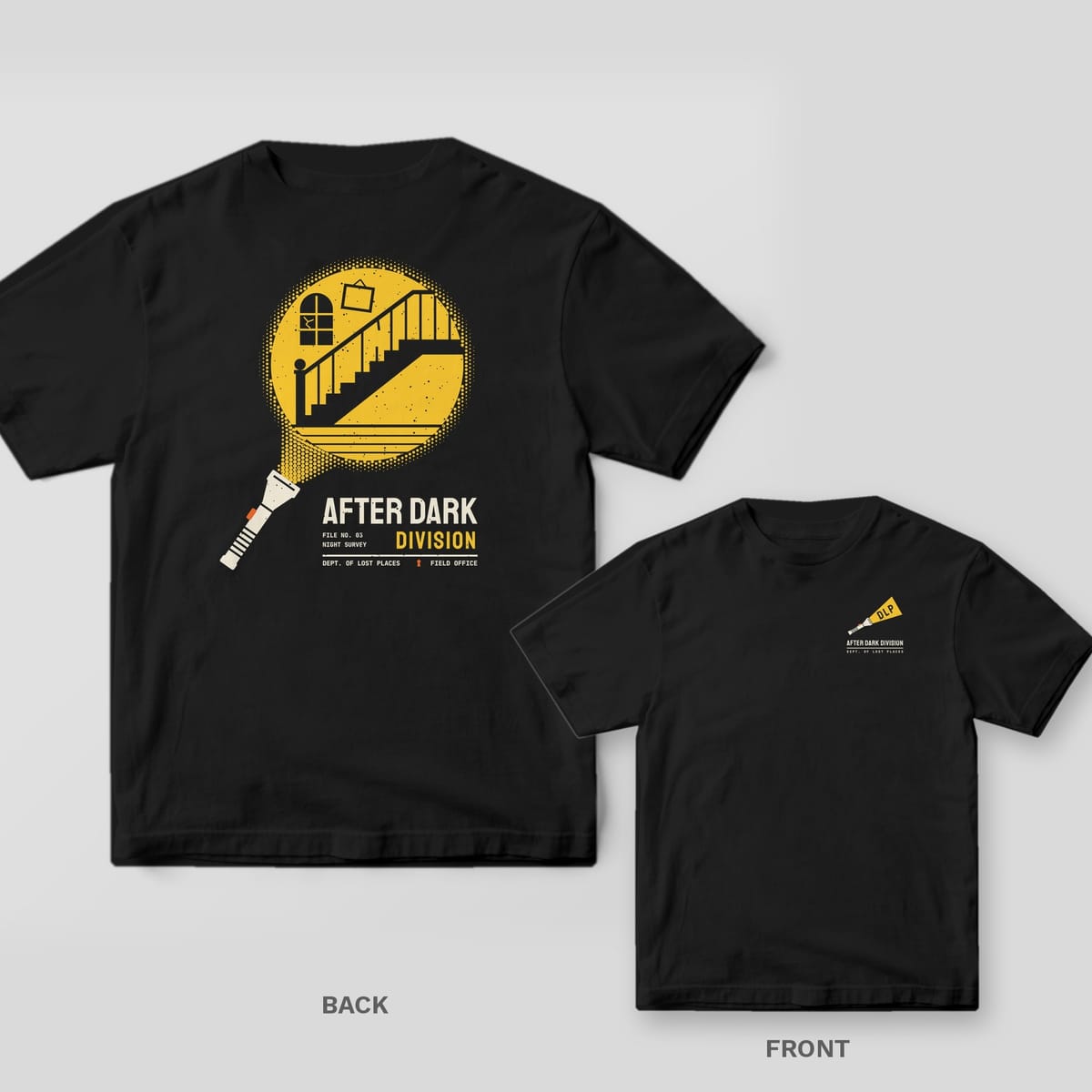 Black Comfort Colors tee shown back and front: the back has a flashlight beam revealing an abandoned staircase above After Dark Division; the chest has a small flashlight whose beam reads DLP.