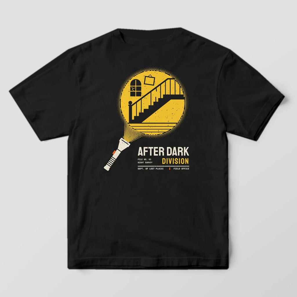 Back of a Black Comfort Colors 1717 tee printed with a cream flashlight throwing a yellow halftone beam that reveals an abandoned staircase, cracked arched window and crooked picture frame, above the words After Dark Division.