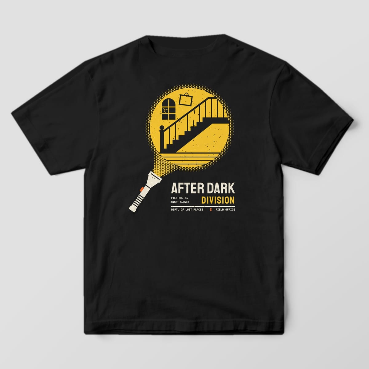 Back of a Black Comfort Colors 1717 tee printed with a cream flashlight throwing a yellow halftone beam that reveals an abandoned staircase, cracked arched window and crooked picture frame, above the words After Dark Division.