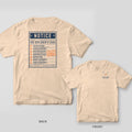 Ivory Comfort Colors tee shown back and front: the back has a navy Notice listing The Explorer's Code with orange numbers and a Final stamp; the chest has a viewfinder framing an orange boot print.