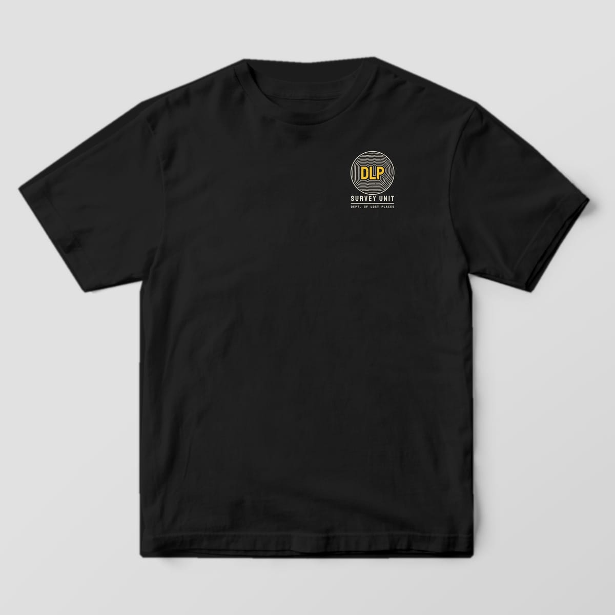 Front of a Black Comfort Colors 1717 tee with a small round badge of cream contour lines around yellow DLP letters above the words Survey Unit on the left chest.