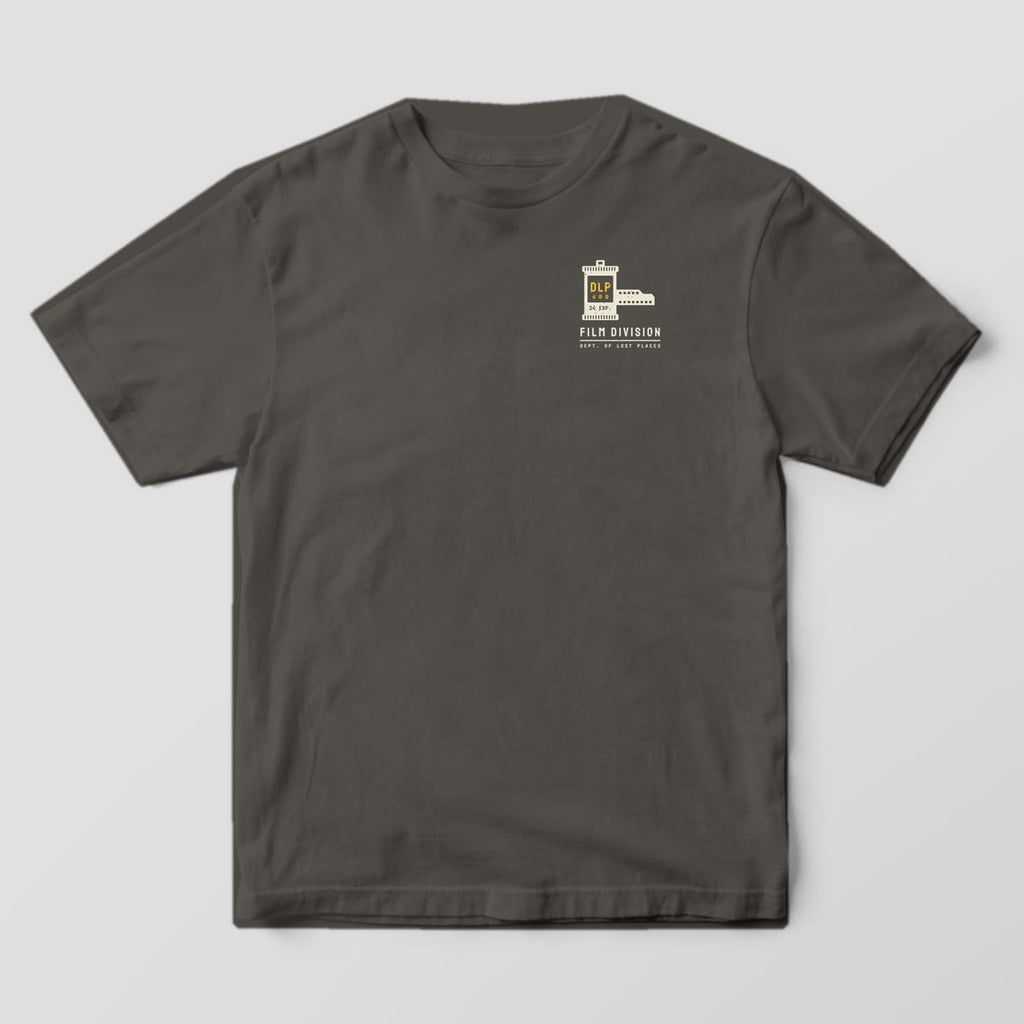 Front of a Pepper Comfort Colors 1717 tee with a small cream film canister labeled DLP 400 with film leader above the words Film Division on the left chest.