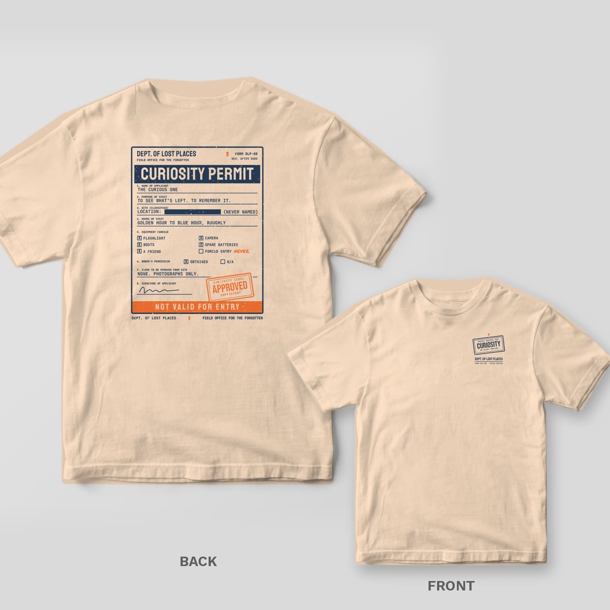 Ivory Comfort Colors tee shown back and front: the back has a navy typewritten Curiosity Permit form with an orange Approved stamp and Not Valid for Entry strip; the chest has a small Curiosity rubber stamp.