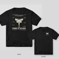 Black Comfort Colors tee shown back and front: the back has a cream field-guide moth perched on a flashlight with specimen labels above Drawn to the Dark; the chest has a small matching moth.