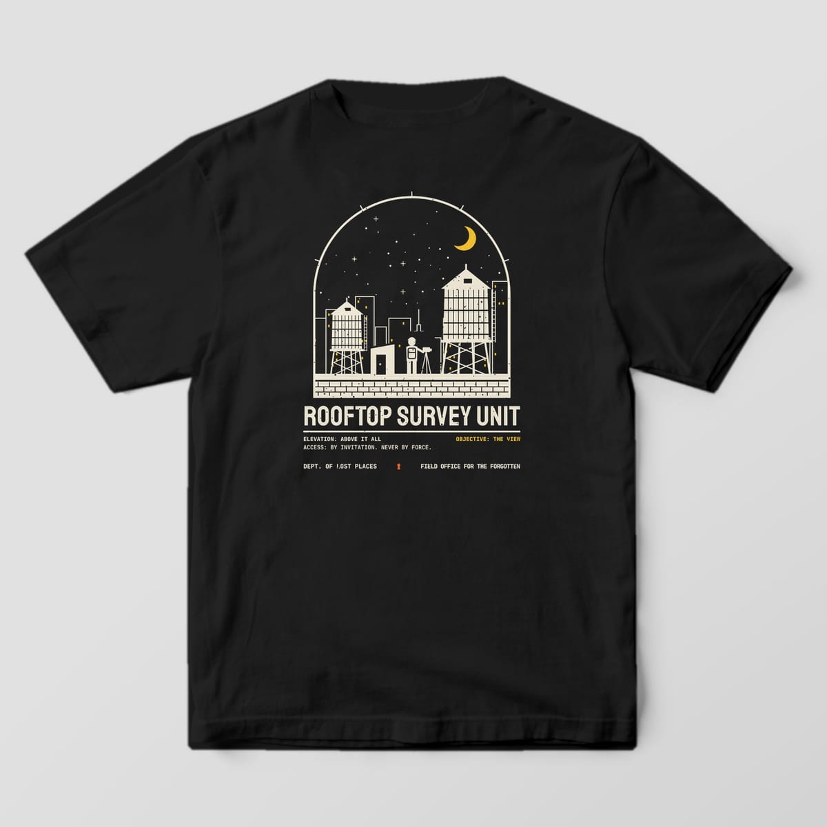 Back of a Black Comfort Colors 1717 tee printed with a cream arched night scene of a city rooftop with two water towers, an explorer at a tripod, lit skyline windows and a yellow crescent moon above Rooftop Survey Unit.