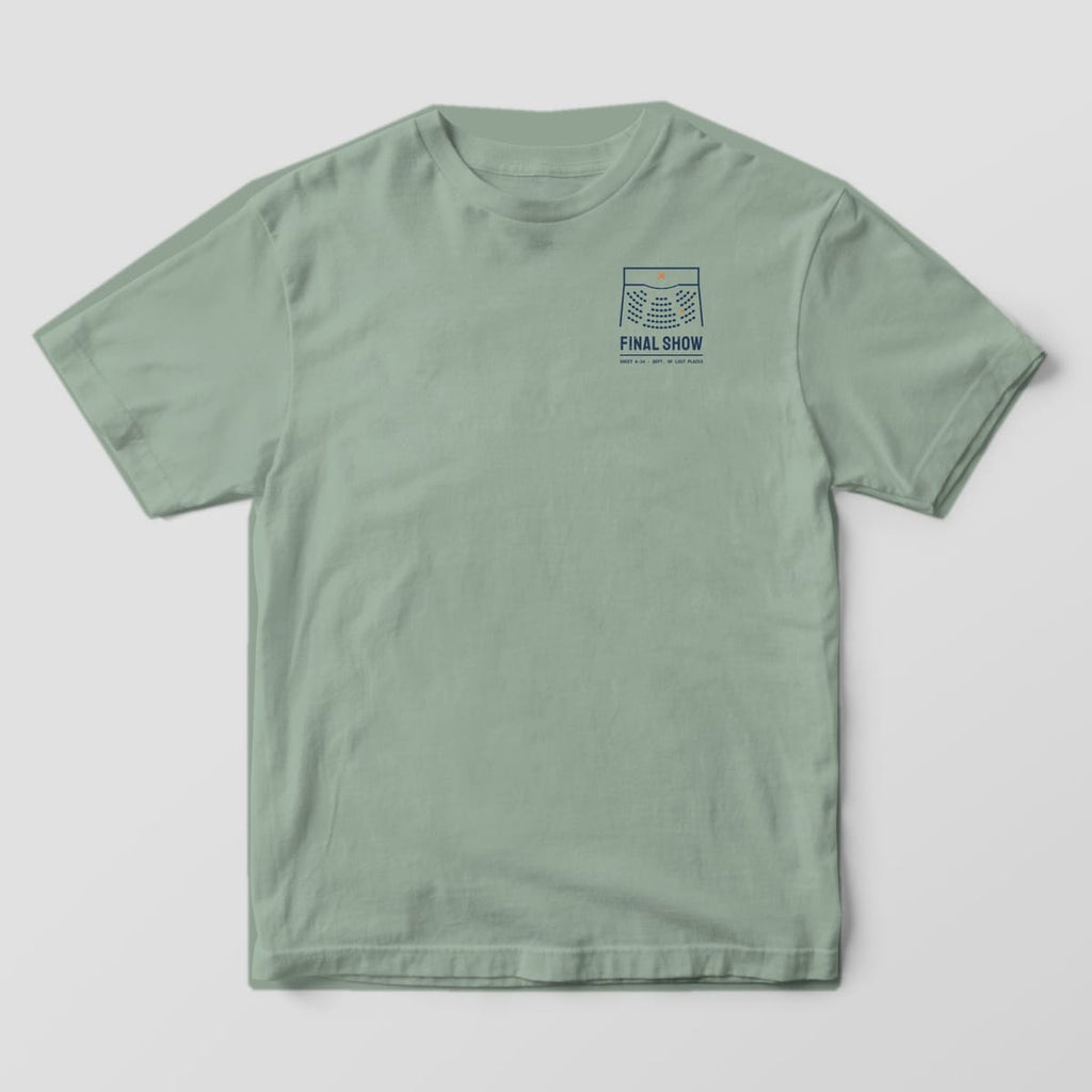 Front of a Bay Comfort Colors 1717 tee with a small navy theater seating plan with an orange X on the stage above the words Final Show on the left chest.