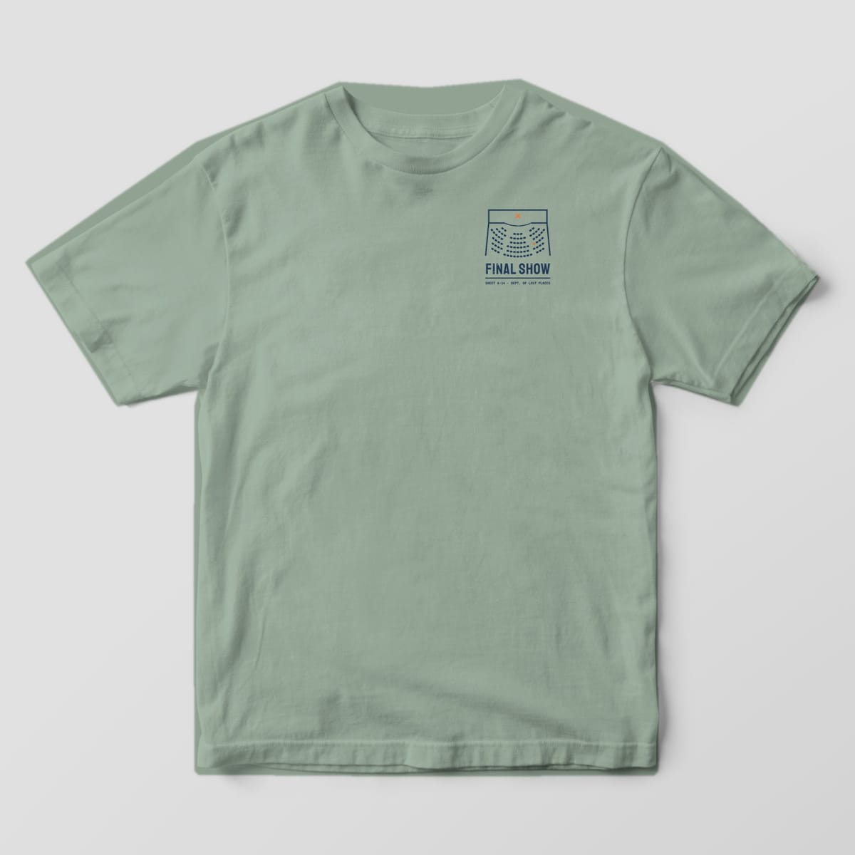 Front of a Bay Comfort Colors 1717 tee with a small navy theater seating plan with an orange X on the stage above the words Final Show on the left chest.