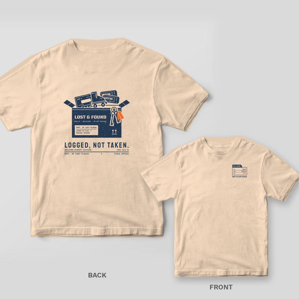 Ivory Comfort Colors tee shown back and front: the back has a navy lost and found box with a cassette, roller skate, tickets and keys above Logged, Not Taken; the chest has a small file folder.
