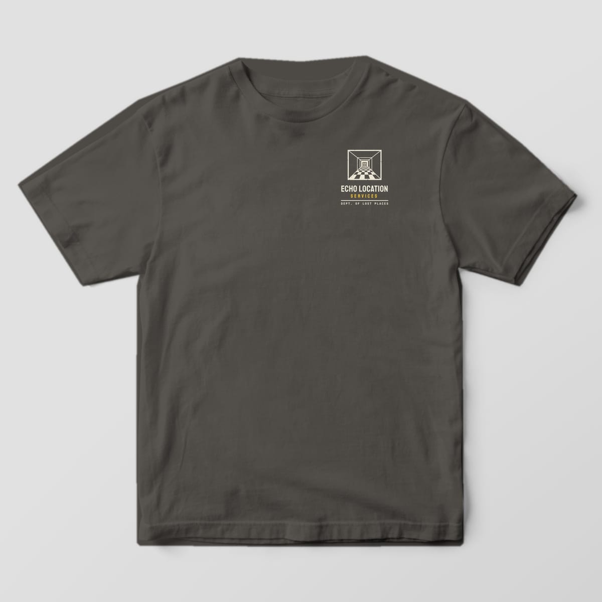 Front of a Pepper Comfort Colors 1717 tee with a small cream hallway in perspective above the words Echo Location Services on the left chest.