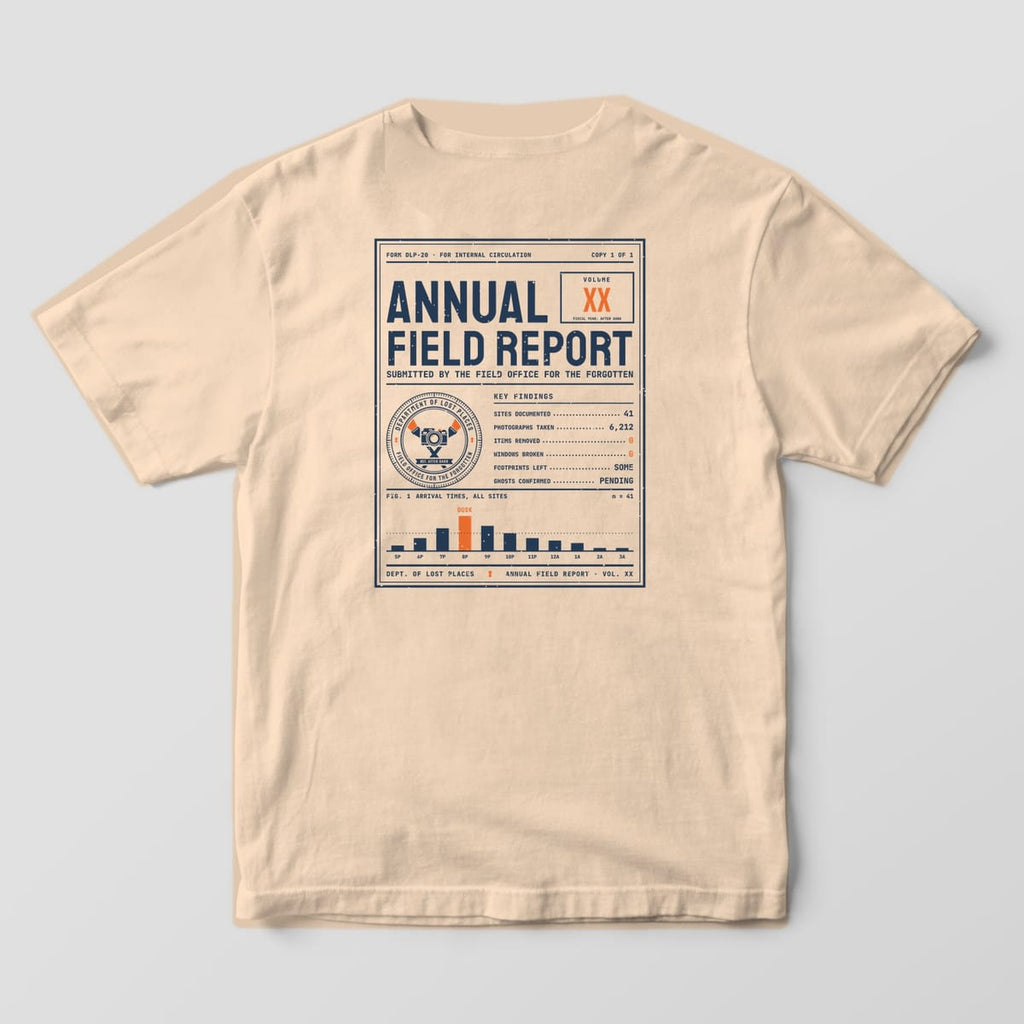 Back of an Ivory Comfort Colors 1717 tee printed with a navy and orange mid-century report cover reading Annual Field Report with a department seal, a list of key findings and a bar chart peaking at Dusk.