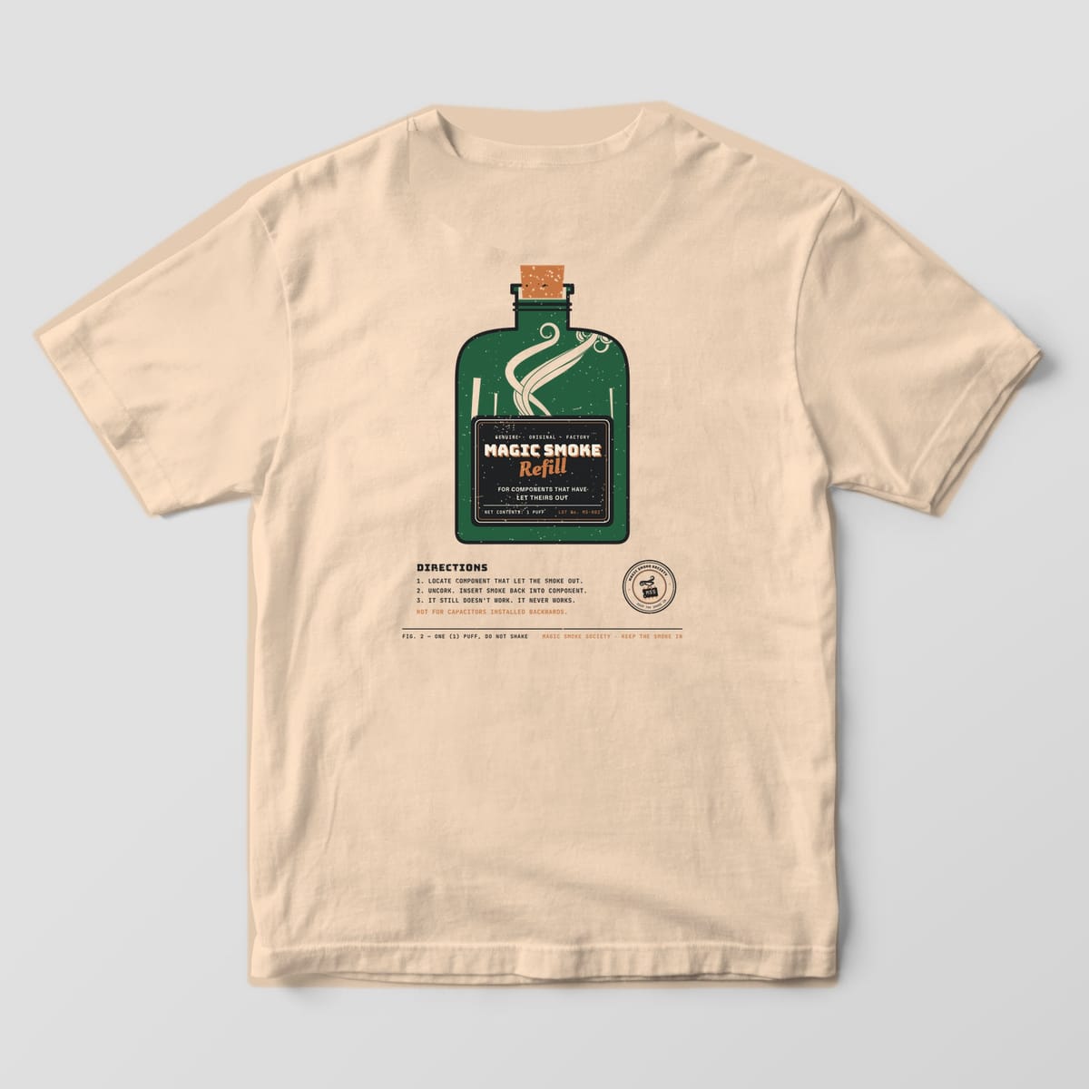 Back of an ivory Comfort Colors 1717 tee with a large corked bottle print labeled Magic Smoke Refill and three funny directions.