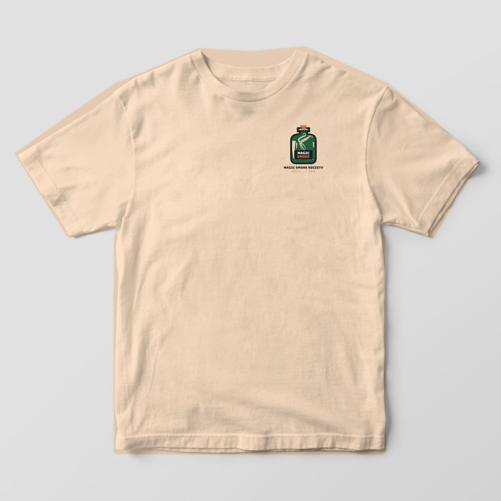 Front of an ivory Comfort Colors 1717 tee with a small green magic smoke bottle on the left chest.