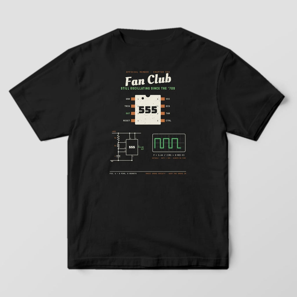Back of a black Comfort Colors 1717 tee with a 555 timer fan club print, chip pinout, astable schematic and scope trace.