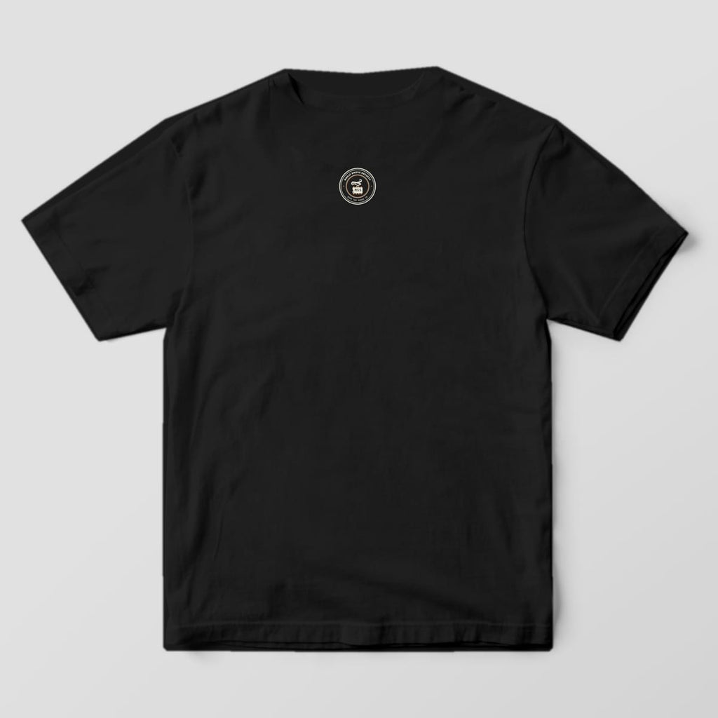 Back of a black Comfort Colors 1717 tee with a small Magic Smoke Society seal below the collar.