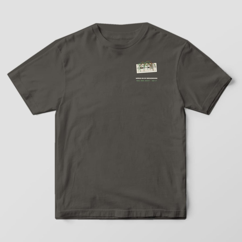 Front of a pepper Comfort Colors 1717 tee with a small breadboard and Works on My Breadboard text on the left chest.