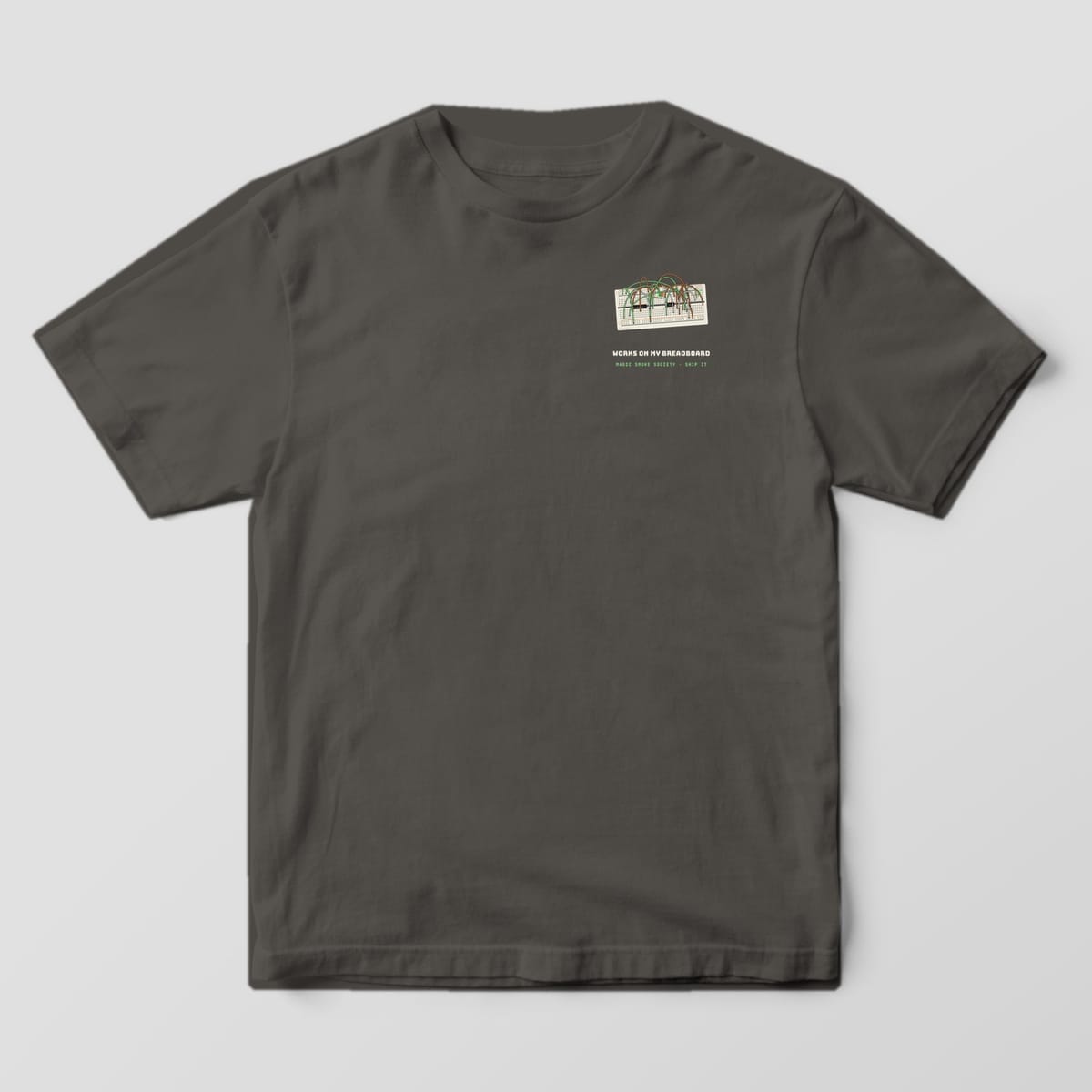Front of a pepper Comfort Colors 1717 tee with a small breadboard and Works on My Breadboard text on the left chest.