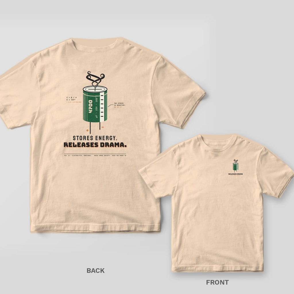 Ivory tee shown back and front: back has a green capacitor with smoke rising from it over Stores Energy. Releases Drama.; front has a small capacitor.