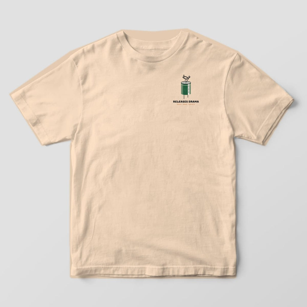 Front of an ivory Comfort Colors 1717 tee with a small smoking capacitor and Releases Drama text on the left chest.