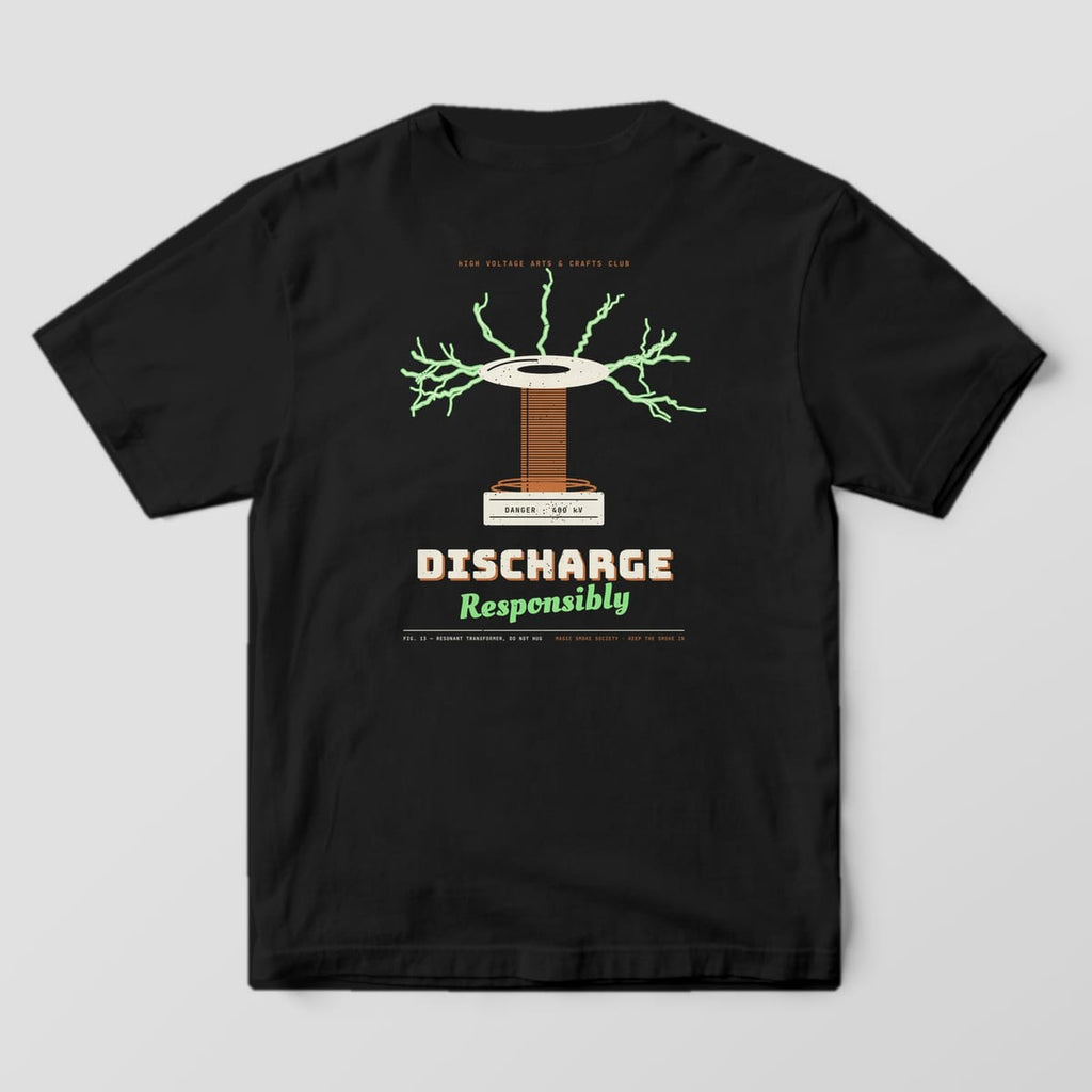 Back of a black Comfort Colors 1717 tee with a coil and green arcs print reading Discharge Responsibly.